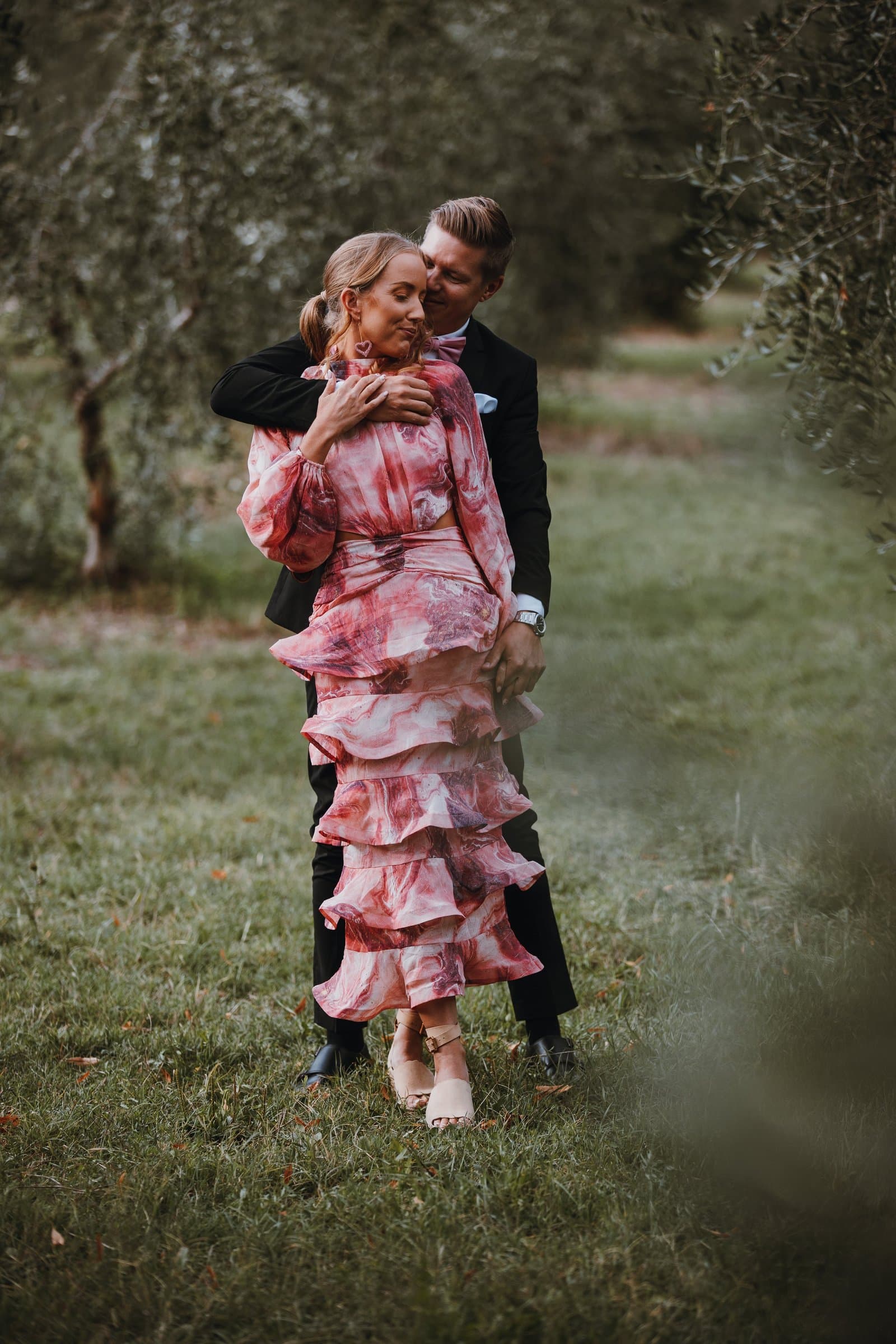 Christopher and Marie embracing in an olive grove